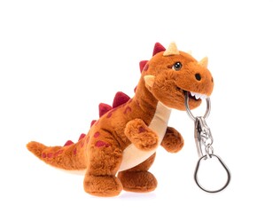 A small, brown toy dinosaur with red spikes and a keychain