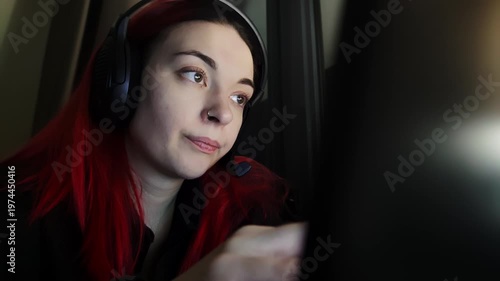 Female customer support agent is engaged in remote assistance during client interaction via video. Woman is speaking into camera. Lady printing on laptop keyboard with focused face deliver guidance 