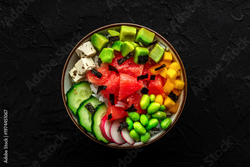 Vegan poke bowl with grapefruit, avocado, mango, edamame, and cucumber