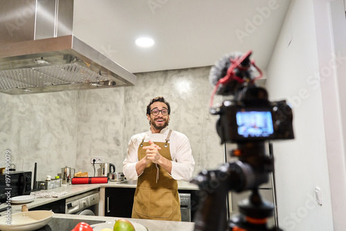 Bilde på lerret Male content creator filming cooking vlog at home