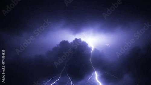 A bright bolt of lightning strikes through the dark night sky during a storm