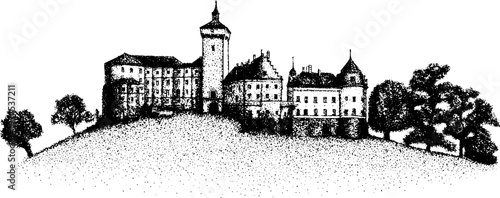 Historic castle complex perched on hill with surrounding trees