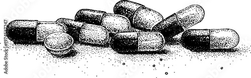 Capsules and tablet scattered on flat surface in monochrome