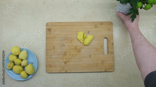 Slicing Potatoes on Wooden Cutting Board