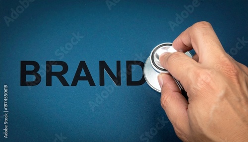 Hand with stethoscope examining brand health marketing concept
