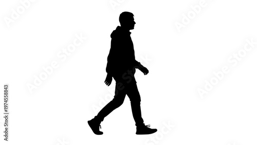 Silhouette of a walking young man.