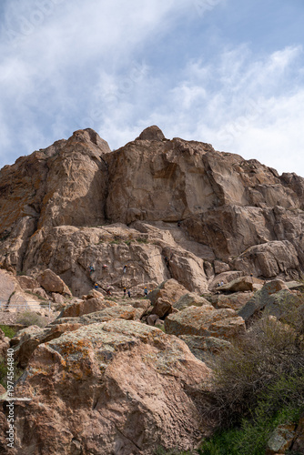 Majestic red rock formations and Buddhist petroglyphs site at Tamgaly Tas. Ili River landscape