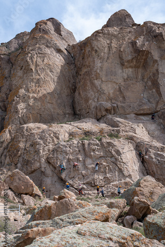 Majestic red rock formations and Buddhist petroglyphs site at Tamgaly Tas. Ili River landscape