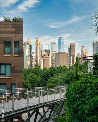 Lower Manhattan skyline with One World Trade Center viewed above lush urban greenery in New York City
