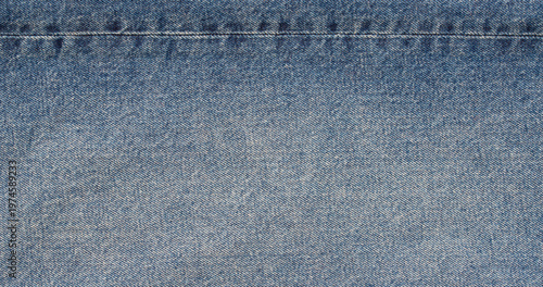 Foto light blue beige denim fabric texture with horizontal seam stitch detail