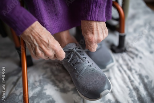 Elderly person with arthritis tying shoelaces with difficulty.