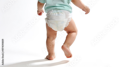 Close-up of a baby's legs and bottom wearing a white disposable diaper, walking on white background. Concept of childcare, hygiene, and infant development.
