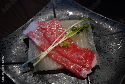 Close up of marbled fatty tuna sashimi slice (Otoro) served in a luxury restaurant