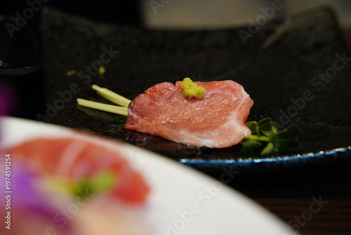 Close up of marbled bluefin tuna otoro sashimi garnished with radish sprouts