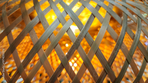 Close-up of woven bamboo with golden backlight, ideal for warm and natural design concepts.