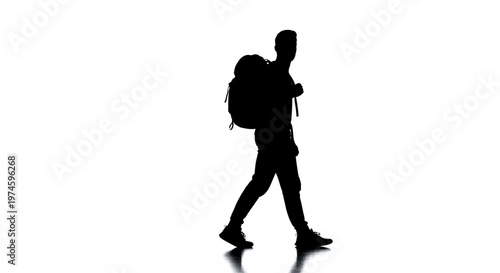 Silhouette of a hiker with a backpack walking against a white background