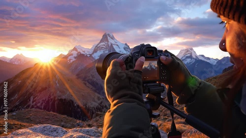 Photographer capturing mountain sunrise landscape scene.