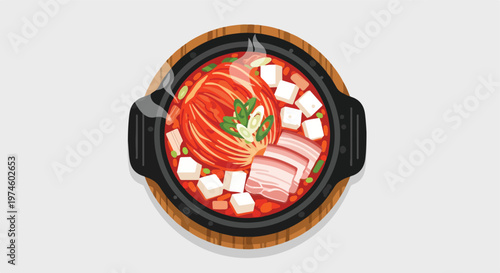 Top view of a hot iron pot filled with spicy kimchi stew, pork, and tofu cubes