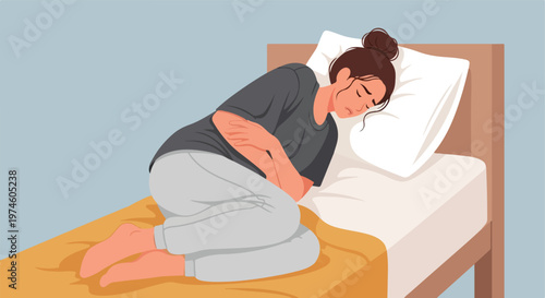 A young woman lying in bed in a fetal position, suffering from abdominal pain