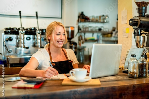 Obraz na płótnie Barista smiling with laptop photo