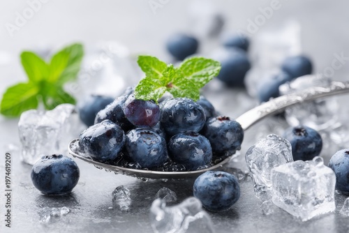 Fresh Blueberries on Spoon with Ice Cubes and Green Leaves Refreshing Healthy Concept