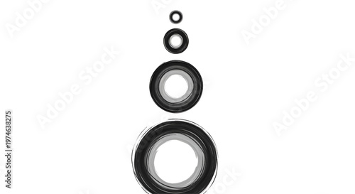 Vertical row of four black rubber o-rings of different sizes isolated on a white background