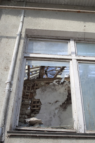 Looking inside a ruined building through a broken window. Close-up. Urban sketches.