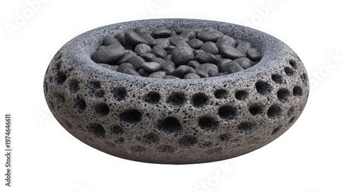 A unique stone bowl filled with small rocks on a black background