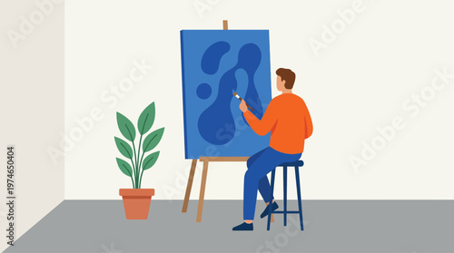 Man painting on blue canvas indoors.