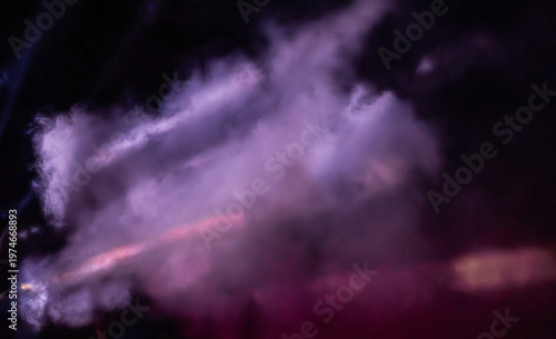 Soft purple and pink mist swirling in an abstract artistic style on a dark background, concept of mystery and atmosphere