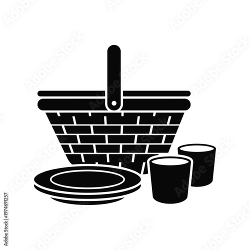 Black silhouette of picnic basket with stacked plates and cups