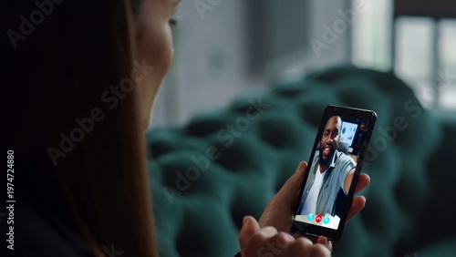 Slika na platnu Businesswoman video calling subordinate by smartphone at home close up