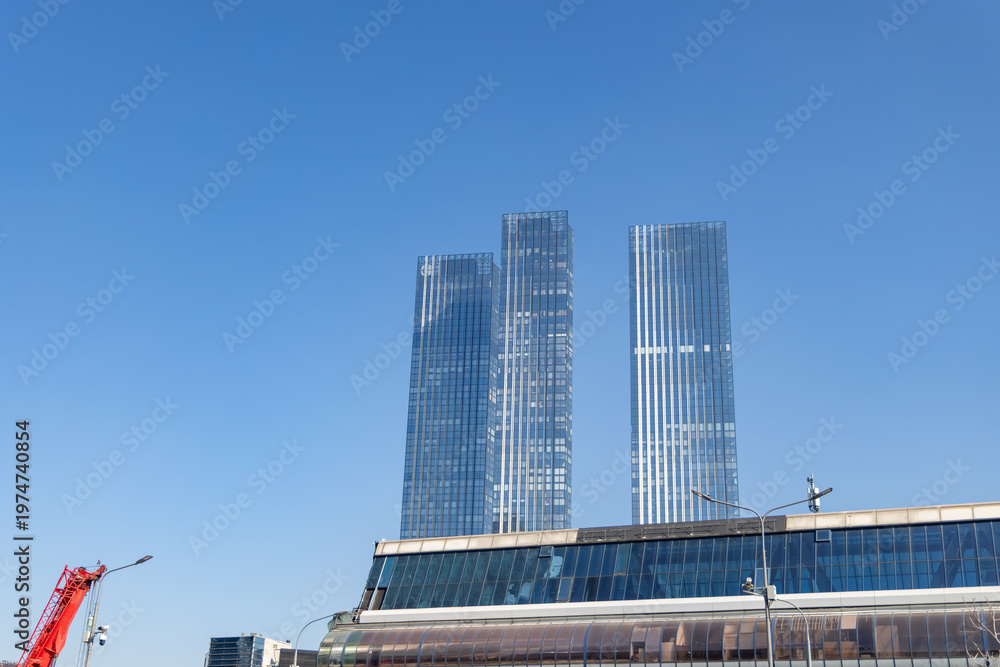 Obraz premium Capital Towers skyscrapers glass facade against clear blue sky in Moscow City business district