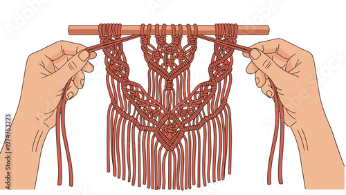 Overhead view of hands crafting an intricate macrame wall hanging with terracotta-colored rope suspended from a wooden rod.