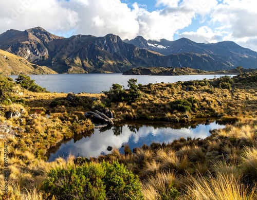 A serene landscape with a still pond reflecting mountains