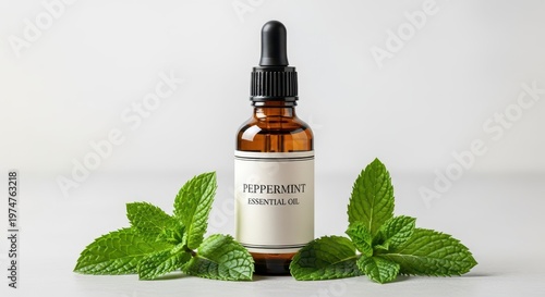 Dropper bottle of potent peppermint essential oil for aromatherapy and natural cooling remedies, surrounded by vibrant green herb leaves on a simple surface, home remedy, studio shot, natural