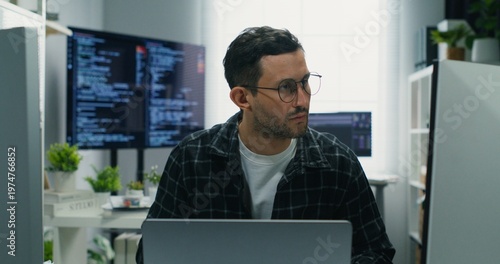Tableau sur toile Overworked Caucasian man, a security analyst, developing robust cyber defense
