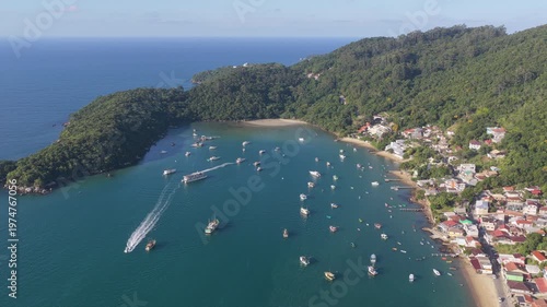 Aerial view of Caixa D’aço bay, Porto Belo, with boats and jet skis.