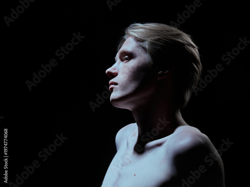 Side profile of young man with strong jawline and soft highlighted skin. Concept of premium skincare branding, luxury cosmetic advertising, beauty campaign and product positioning.