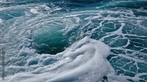 Foaming ocean waves crashing into dark blue seawater