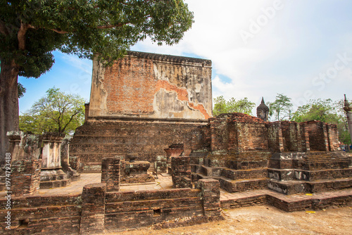 Ancient stone pillars ,columns at Sukhothai province Thailand, stand tall against a clear blue sky. Weathered columns exhibit showcasing historical architecture.