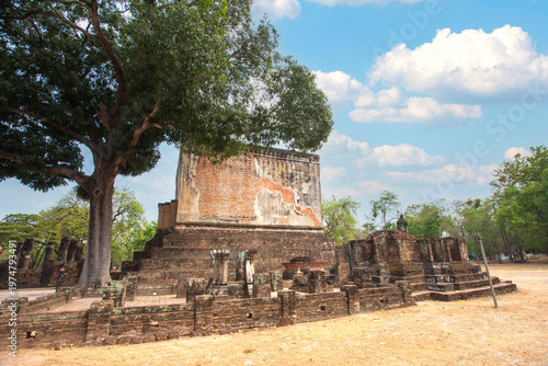 Ancient stone pillars ,columns at Sukhothai province Thailand, stand tall against a clear blue sky. Weathered columns exhibit showcasing historical architecture.