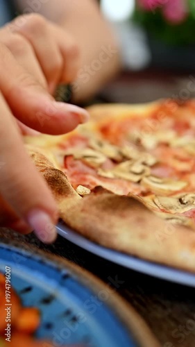 Girl Eats Fresh Pizza At A Cafe And Pulls Off A Piece At The Table