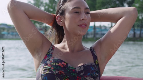 Wallpaper Mural An olive skinned woman enjoys the sun and wind on her skin as she rides on a boat. Torontodigital.ca