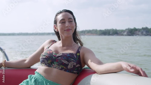 Wallpaper Mural A gorgeous young Latina woman enjoys the wind blowing through her hair as she rides a boat. Torontodigital.ca