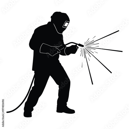 Silhouette of a welder wearing a protective mask and gloves actively performing welding work with sparks flying from the welding torch demonstrating a skilled 