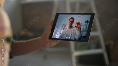 Remote doctor talking pad screen at clinic closeup. Patient hands holding tablet
