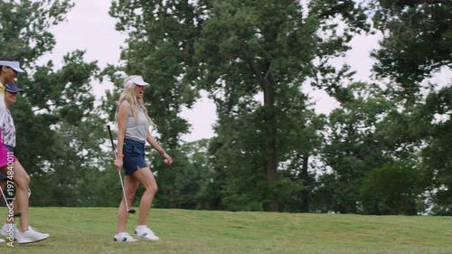 Wallpaper Mural Three women walk with purpose across a lush golf course on a nice day. Torontodigital.ca