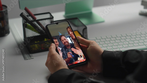 Woman looking smartphone screen at work place closeup. Lady watching video call