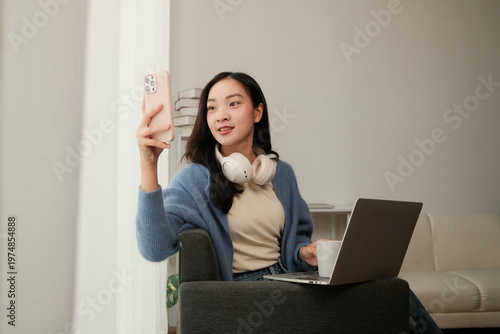 Young woman making video call at home with laptop